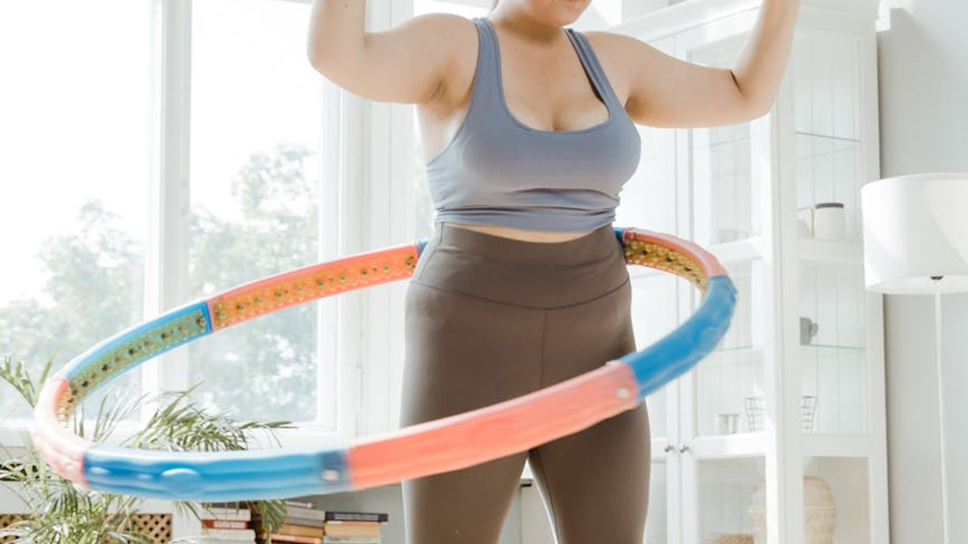 Person doing light cardio movements in a bright airy room.